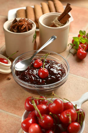 cherry jam in the glass bowl with fruits around - closeupの写真素材