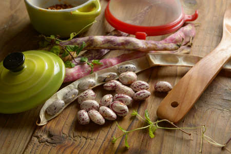 beans in the pod on the wooden table - closeup