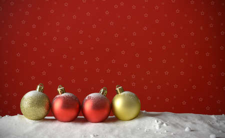 row of Christmas balls on the snow and red background - closeupの写真素材