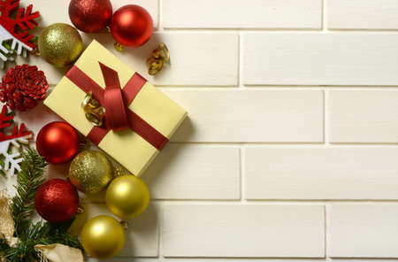 gift package and Christmas decorations on the white wall - closeup
