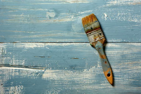 dirty paintbrushes on blue wooden table - closeupの写真素材