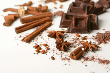 pieces of chocolate, cinnamon, star anise and cocoa powder on the white background - closeupの写真素材