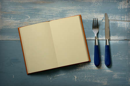 recipe book with blank pages with fork and knife - closeupの写真素材
