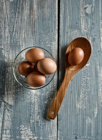 eggs in the glass bowl on the wooden table - closeupの写真素材
