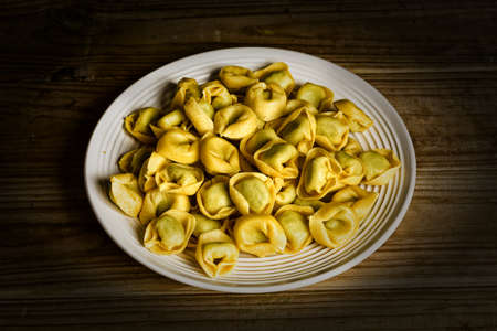 stuffed tortellini not cooked on the plate - traditional Italian food - closeupの写真素材