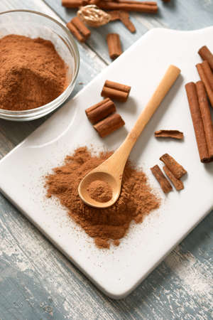 cinnamon powder on white cutting board - closeup