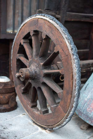 Traditional rural agriculture shown on the weathered and rustic wooden wheels of an old farm wagonの写真素材