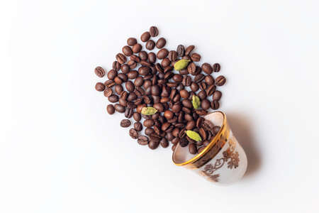 Roasted coffee beans and a coffee cup isolated on white background from a top viewの写真素材