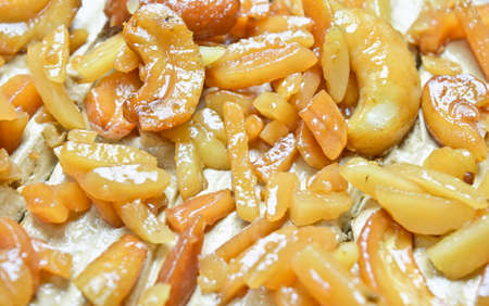 peanut and cashew nut cake on wooden plate