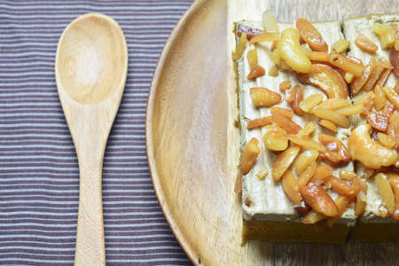 peanut and cashew nut cake on wooden plate