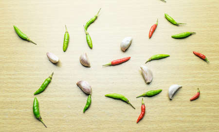 chili pepper and garic on wooden tableの写真素材