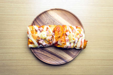 pizza on wooden plateの写真素材