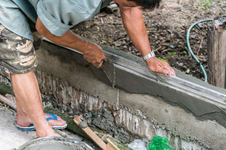 plasterer concrete worker at wall workの写真素材