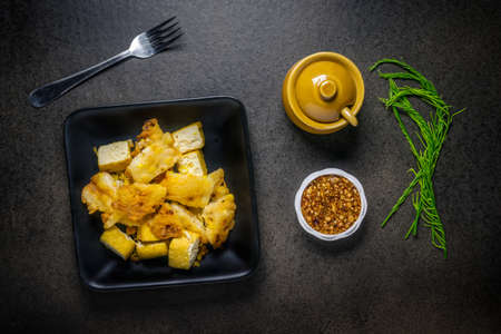 Fried tofu with bean Sauce and vegetable on dark backgroundの写真素材