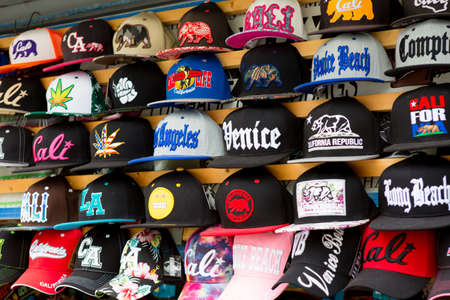 LOS ANGELES, CA - JUNE 19, 2017: Display of caps hats for sale on sidewalk outside a souvenir shop in Venice Beachのeditorial素材