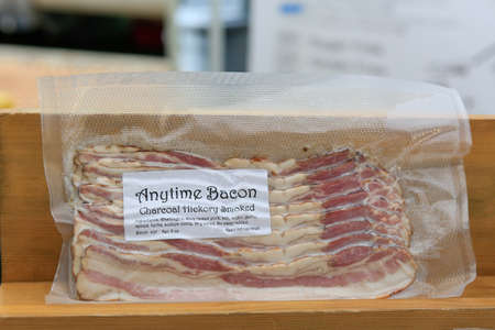 Close up view of Package of Charcoal hickory smoked bacon at the farmers' market.のeditorial素材