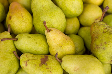 Close up of  green pears for sale on a farmers market.