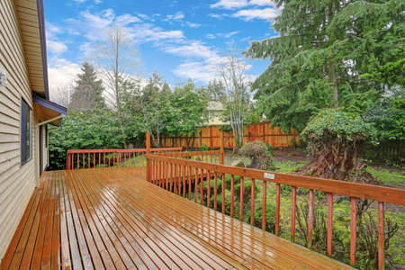 Backyard view of a spacious two story home with large entertainment deck.