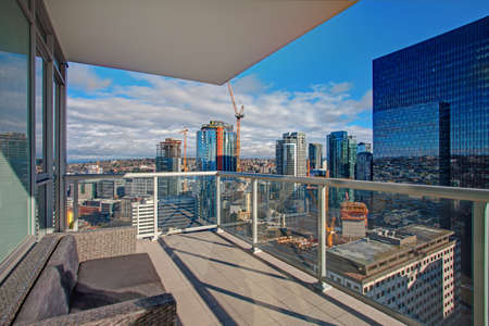 Apartment building with sunset view of downtown Seattle from the balcony patio.の写真素材