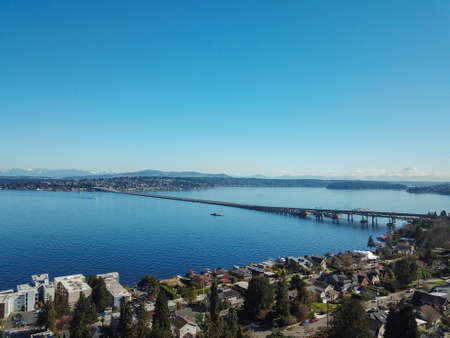 Amazing aerial view, a bridge in blue waters of Lake Washington with mountain range in the background.の写真素材