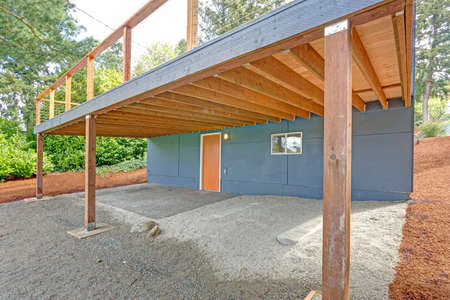 Grey Home exterior with outdoor garage space.