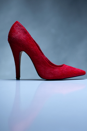 Red high heels isolated on gray backgroundの写真素材