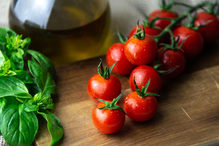 Cherry tomatoes with basil and oilの写真素材