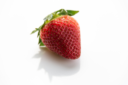 Red strawberry with green leaves isolatedの写真素材