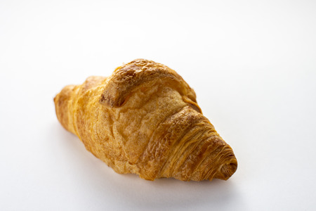 Fresh baked croissant isolated on white backgroundの写真素材