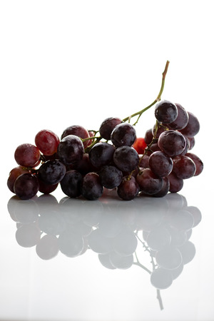 Red grape cluster isolated on white backgroundの写真素材