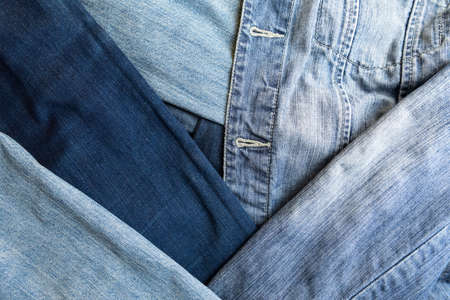 Different shades of blue denim fabric. Detail of several layers of jeans.の写真素材