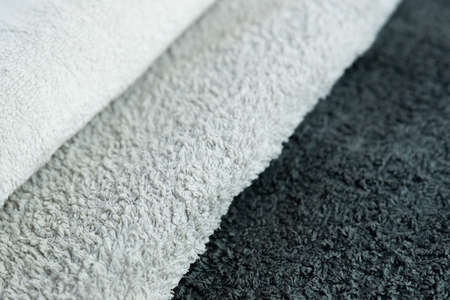 Background of the detail of a terrycloth towels in different shades of gray and white.の写真素材