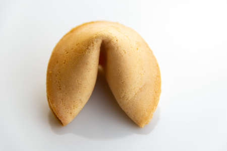 Chinese fortune cookie with golden and brown color and white backgroundの写真素材