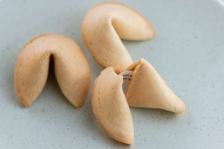 Chinese fortune open cookies with golden and brown color and white backgroundの写真素材