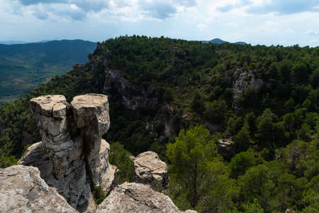 View of a mountain landscape in the Prades area in Catalonia with green and blue tones of the sky and cloudsの写真素材