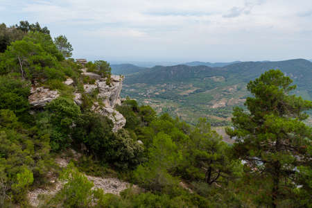 View of a mountain landscape in the Prades area in Catalonia with green and blue tones of the sky and cloudsの写真素材