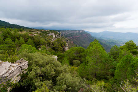 View of a mountain landscape in the Prades area in Catalonia with green and blue tones of the sky and cloudsの写真素材