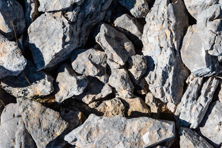 Background of various stones with different gray and white tones and with texture in the middle of natureの写真素材