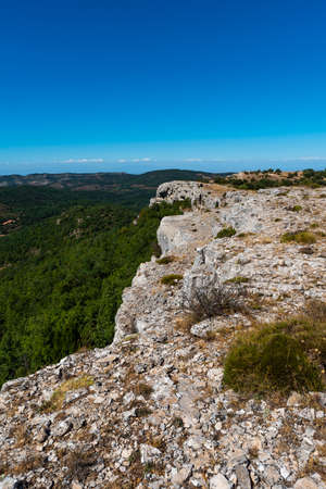Landscape at the top of the mountain on a summer day with vegetation and trees and rocks with bright blue sky in Catalonia, Spainの写真素材