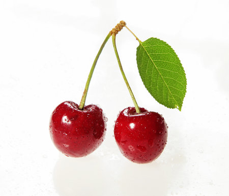 two cherries with cut-out leavesの写真素材