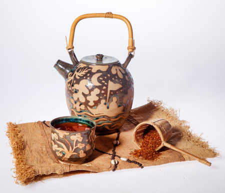 Teapot infused with African red rooibos tea and cupの写真素材