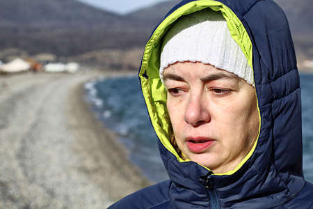Women wrapped by walking on the beach in winterの写真素材