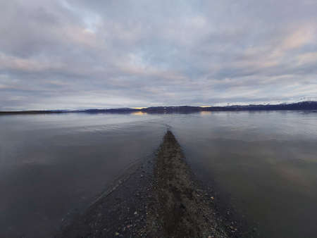 Sunset in the bay with pebble beachの写真素材