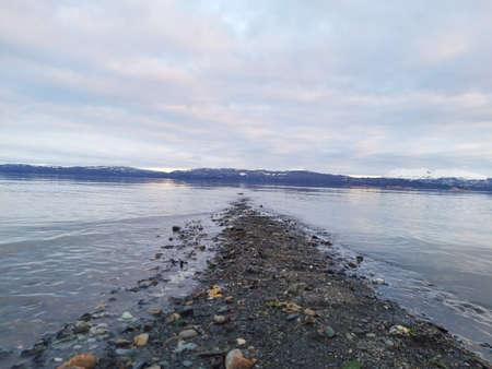 Sunset in the bay with pebble beachの写真素材