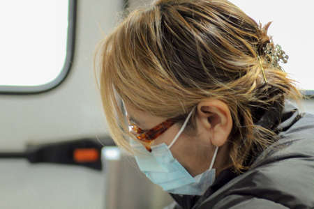 Nurse with her face mask on in the ambulance