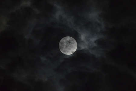 Tamil Nadu, India - June-06-2020: Penumbral lunar eclipse behind cloudsのeditorial素材