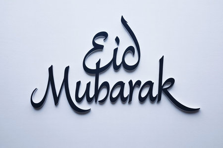 The image features elegant calligraphy of the phrase 'Eid Mubarak' against a plain background. The text is written in a flowing, cursive style, conveying a sense of celebration and joy associated with the festive occasion of Eid. The simplicity of the background emphasizes the beauty and significance of the message, making it a perfect greeting for the joyous holiday.の素材