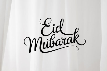 An elegant image featuring the phrase 'Eid Mubarak' in a stylish, cursive font against a plain white background. The text is centered and written in black, conveying a festive and joyful greeting for the Eid celebration.の素材