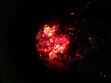 Red-hot coals and fire on them. Coals in the grill with flying lights.