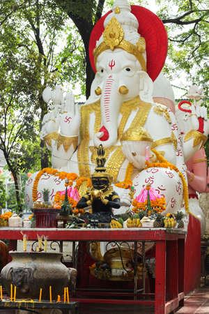 White ganesha statue in sitting action with many decoration
